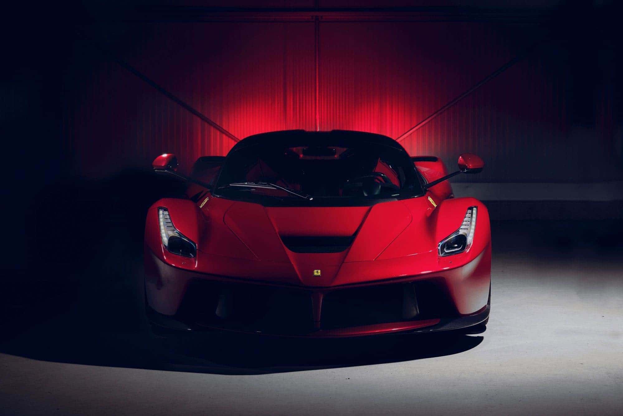 Red Ferrari LaFerrari in a dim studio with red rim-light